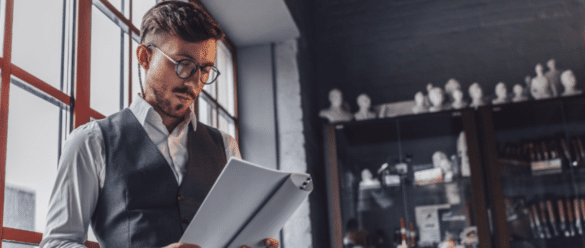 Person looking down, reading a paper script.