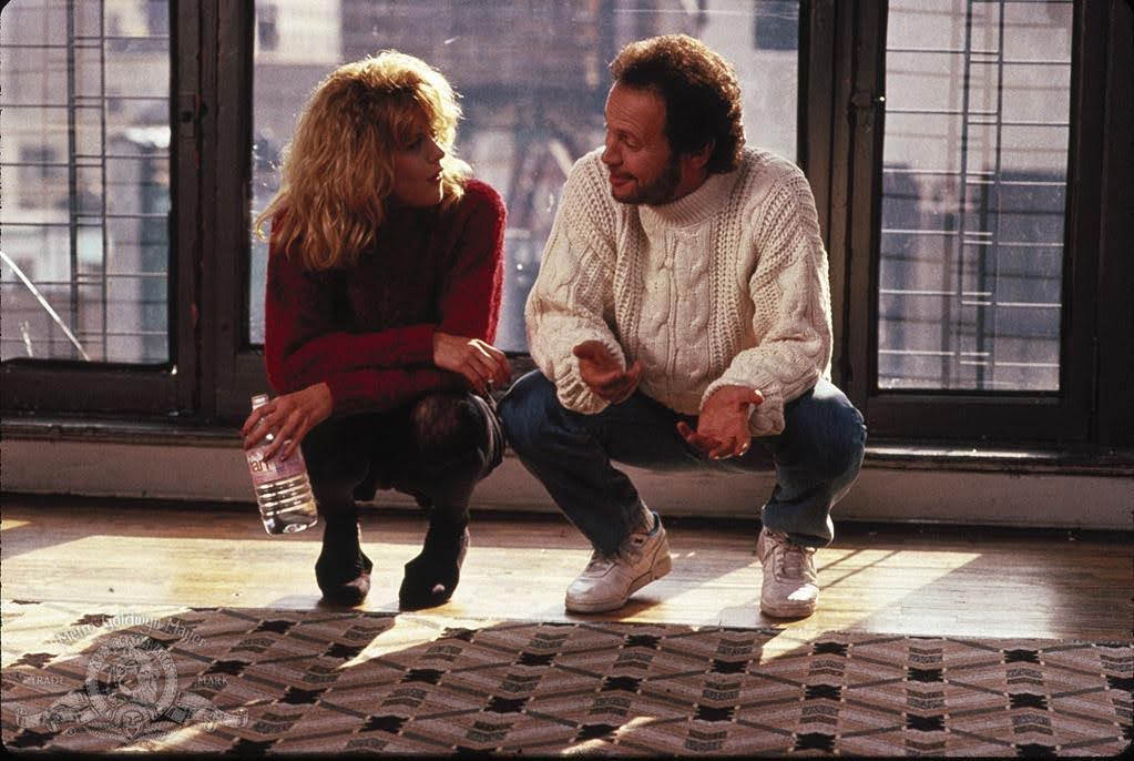 A scene from the classic movie, When Harry Met Sally. Harry and Sally crouch in front of a window.